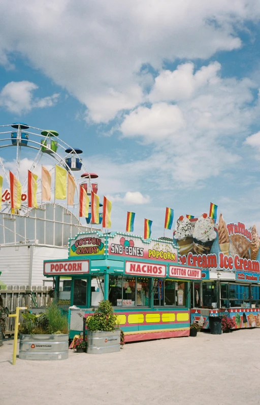 an amusement park with a ferris wheel in the background, ice cream on the side, shot onfilm, colorful signs, photograph