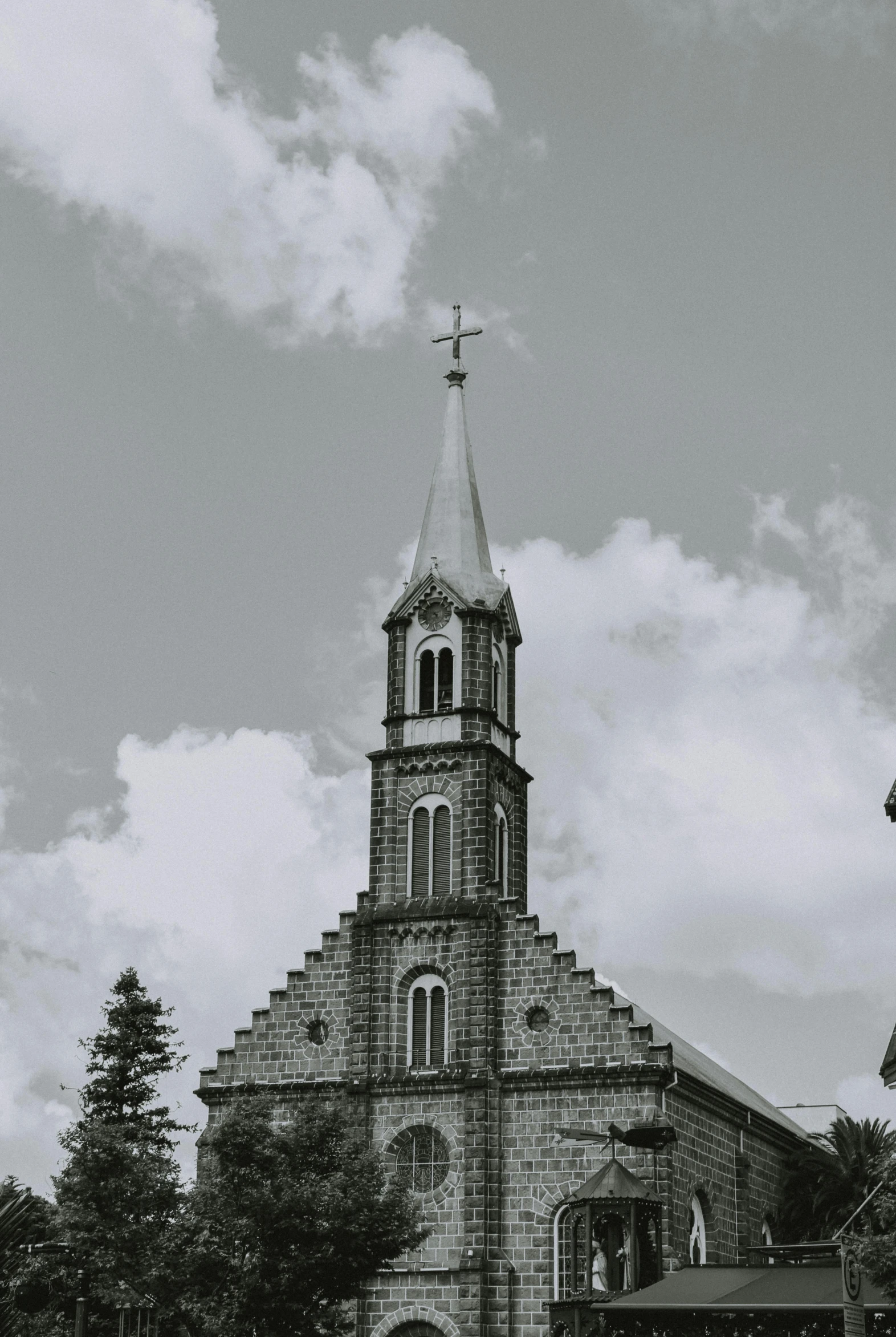 a black and white photo of a church, a black and white photo, unsplash, quebec, brown, in karuizawa, spire