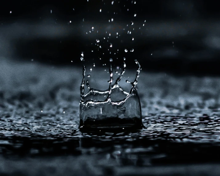 a black and white photo of a water drop, an album cover, pexels contest winner, glass rain, floating crown, it\'s raining, video