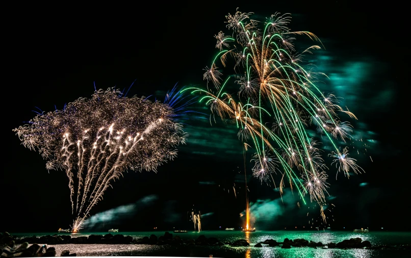 a couple of fireworks that are in the sky, by Ejnar Nielsen, pexels contest winner, magical island, chartreuse and orange and cyan, thumbnail, group photo