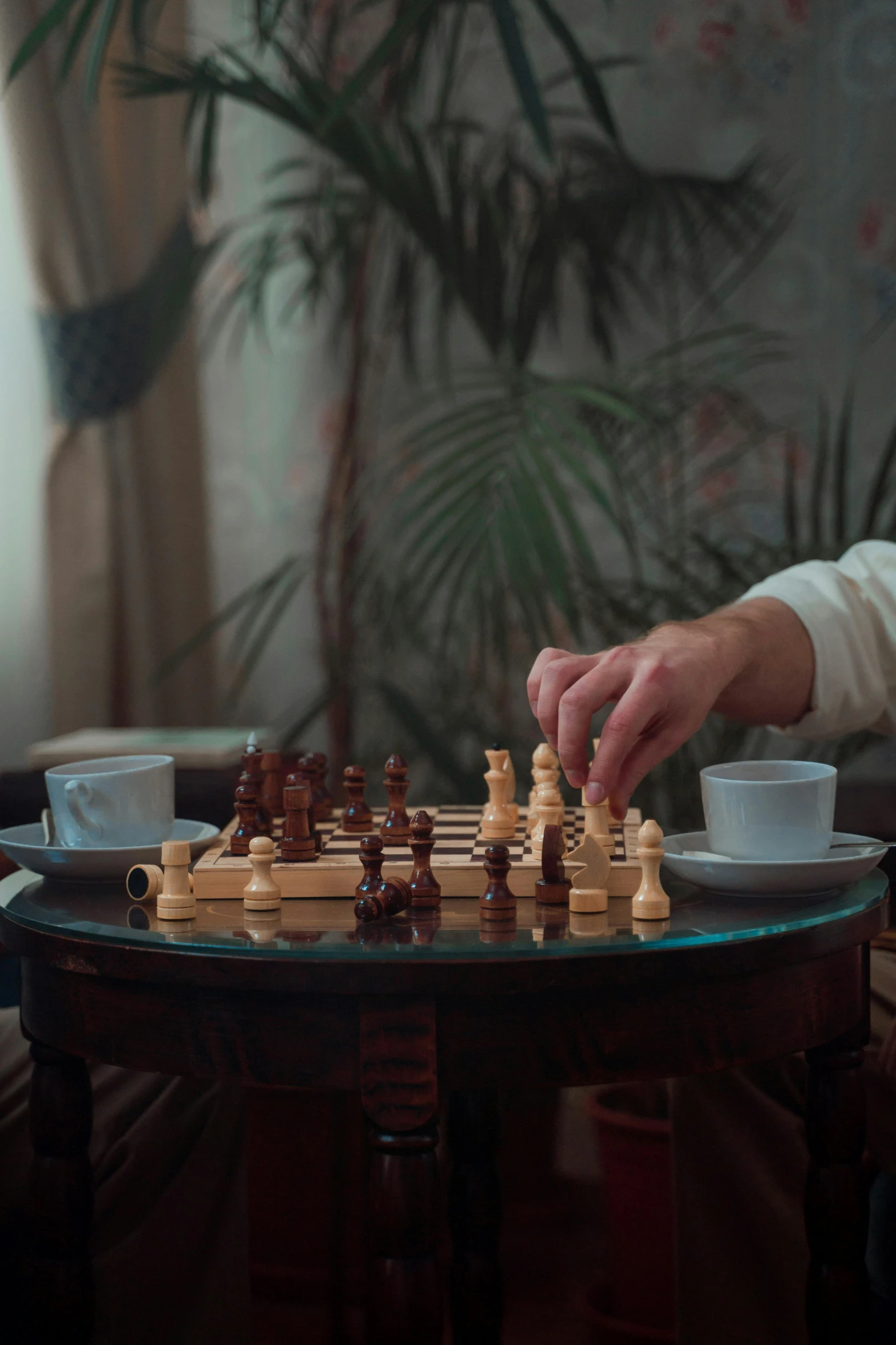 a man playing a game of chess in a living room, a still life, unsplash contest winner, moroccan tea set, movie still 8 k, cinematic. by leng jun, in-game cinematic