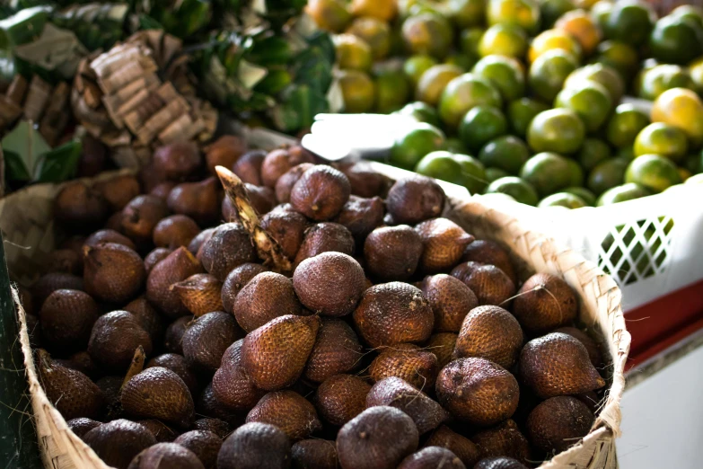 a basket filled with lots of fruit sitting on top of a table, by Matt Stewart, hurufiyya, passion fruits, samoan features, market, thumbnail