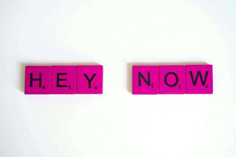 two pink scrabbles with the words hey now written on them, a picture, trending on unsplash, set against a white background, claymation style, long view, on a gray background