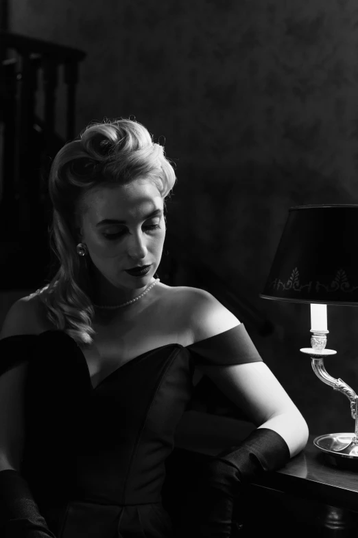 a black and white photo of a woman sitting at a table, inspired by George Hurrell, tumblr, amber heard, square, dramatic lighting; 4k 8k, 1950s
