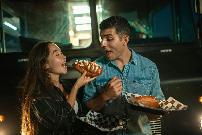 a man and a woman standing in front of a food truck, pexels contest winner, eating garlic bread, ska skeleton and girlfriend, hot dog, studio photo