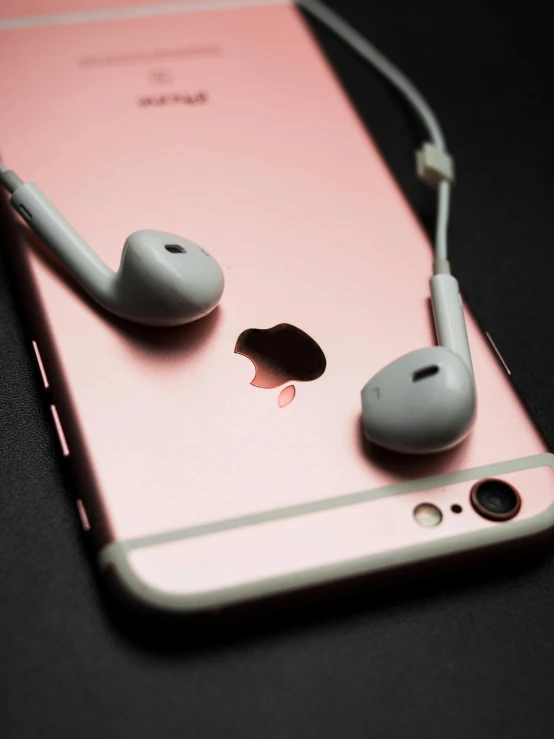 a pair of headphones sitting on top of an iphone, trending on pexels, light pink, corporate phone app icon, porcelain skin ”, shot on iphone 6