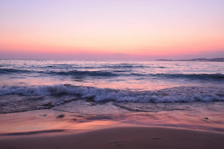 a large body of water sitting on top of a sandy beach, pexels contest winner, romanticism, pink sunset hue, manly, waking up, a photo of the ocean