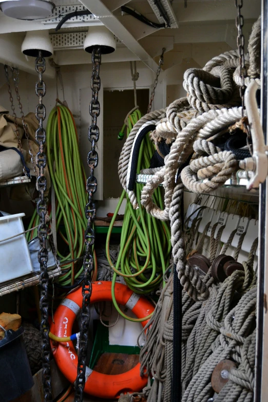 a room filled with lots of different types of rope, slide show, boat, up-close, garage