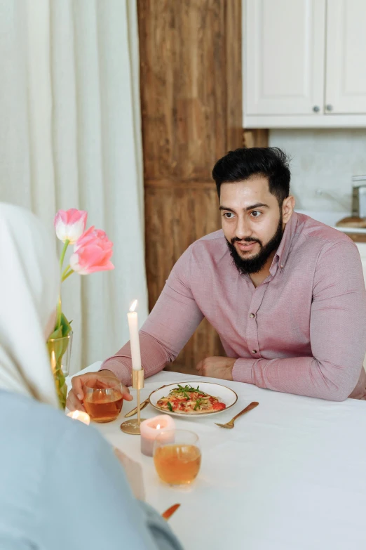 a man sitting at a table with a plate of food, romantic lead, riyahd cassiem, serving suggestion, concerned