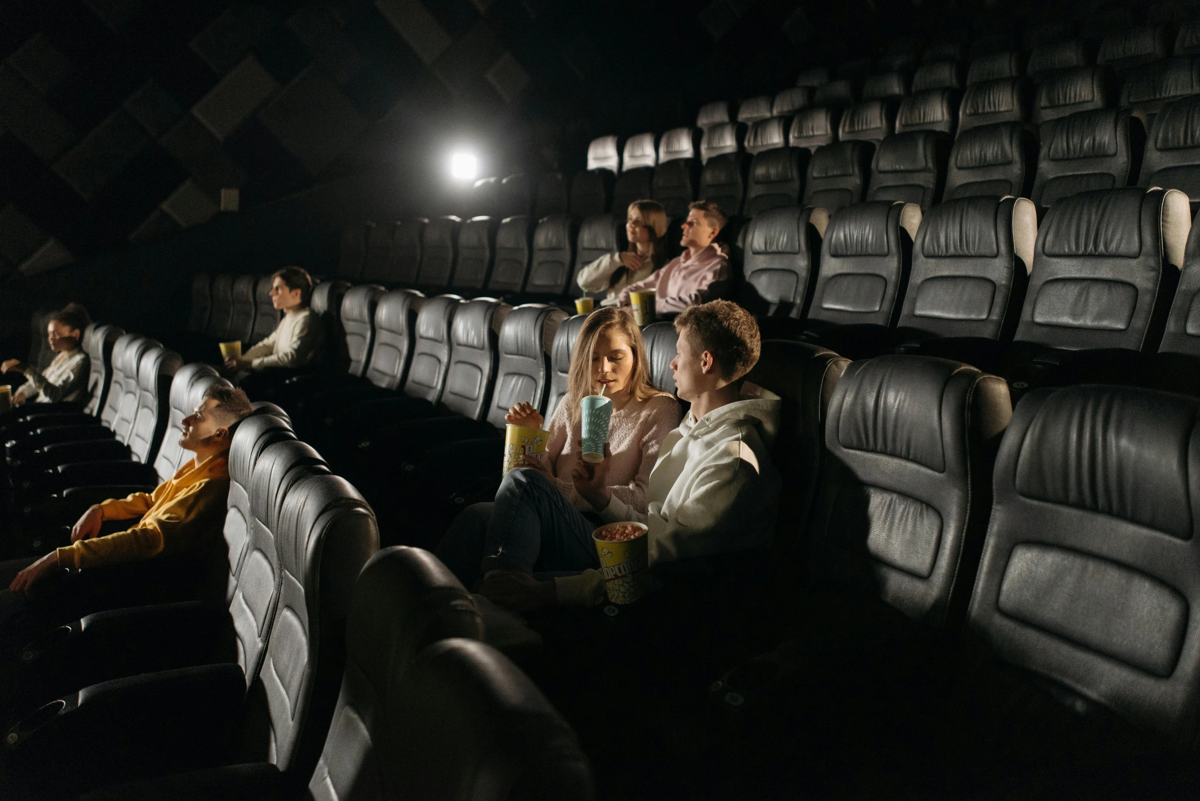 a group of people sitting in a movie theater