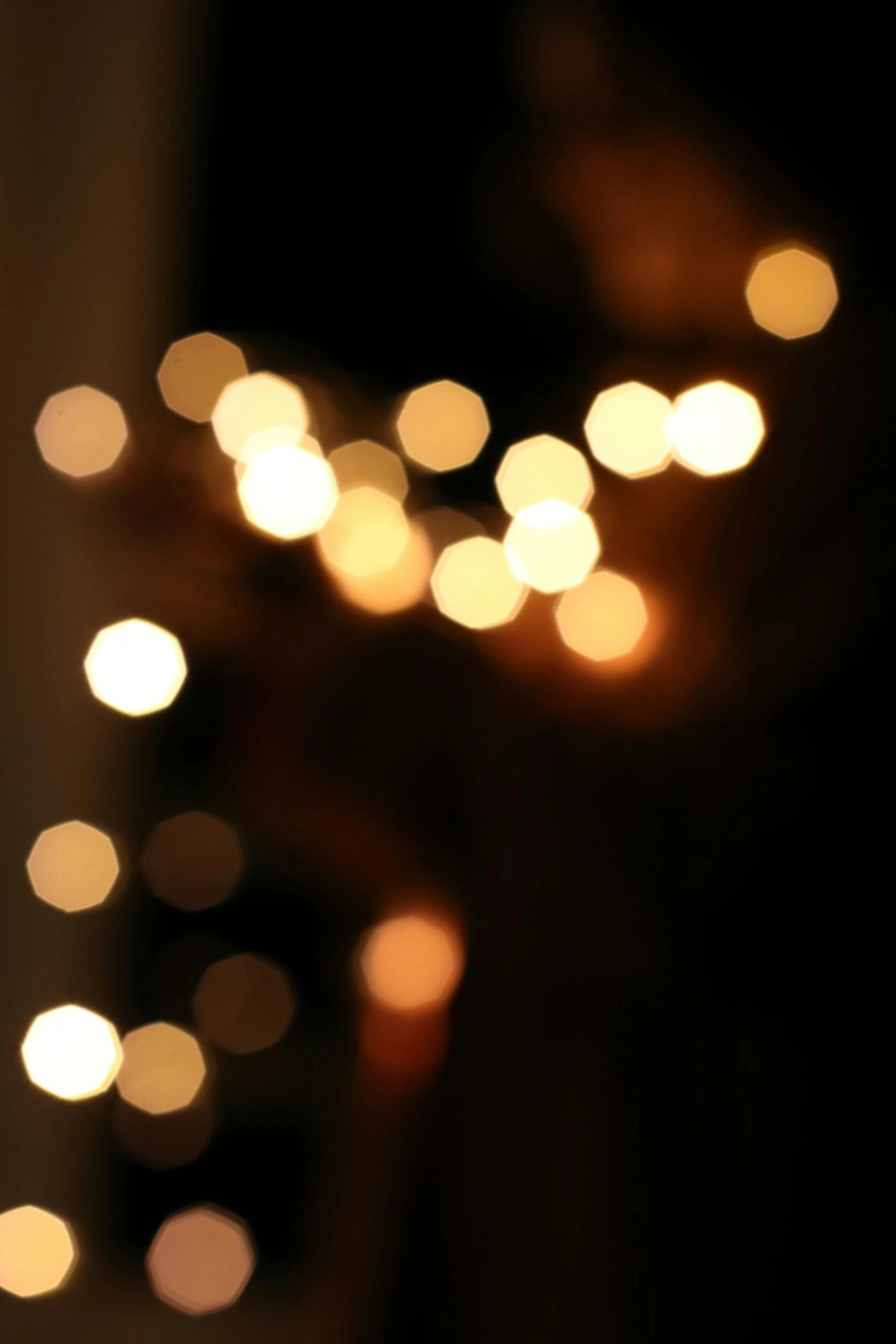 a close up of a person holding a cell phone, light and space, string lights, soft diffused light, candlelight, boke