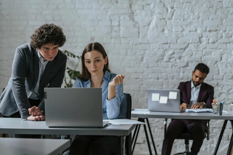 a couple of people sitting at a table with laptops, trending on pexels, standing in class, avatar image, focused photo, lachlan bailey