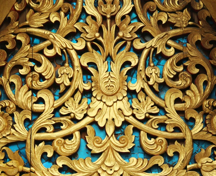 a close up of a gold and blue wall, by Kamāl ud-Dīn Behzād, flickr, art nouveau, intricate wood carving, javanese mythology, instagram post, cyan and gold scheme
