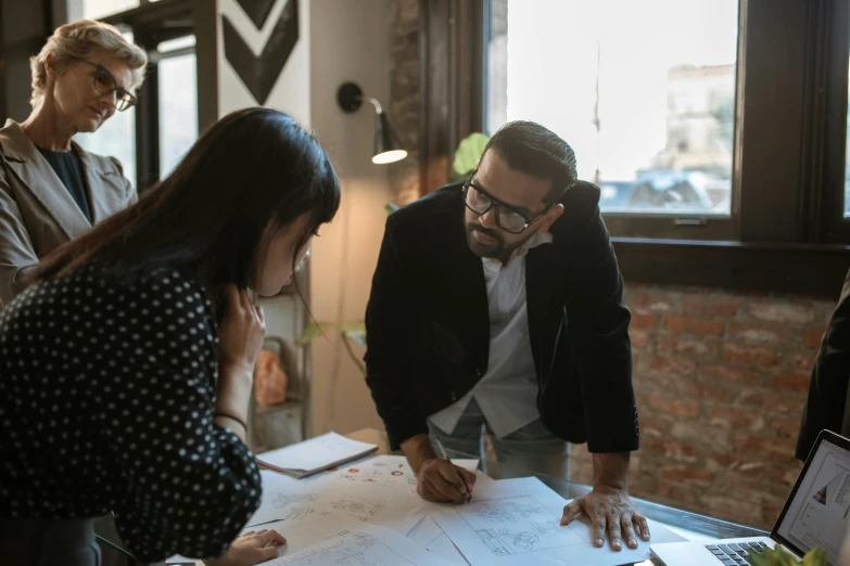 a group of people standing around a table, 9 9 designs, profile image, architect, hziulquoigmnzhah