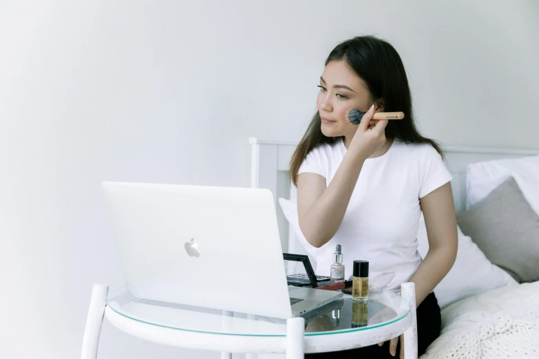 a woman sitting on a bed talking on a cell phone, trending on pexels, tachisme, white powder makeup, sitting at a computer, malaysian, avatar image