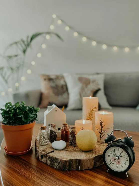 a coffee table with candles and a clock on it, pexels contest winner, string lights, happy ambience, low quality photo, lights with bloom