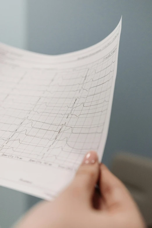 a close up of a person holding a piece of paper, pulse, insanly detailed, diagnostics, lines