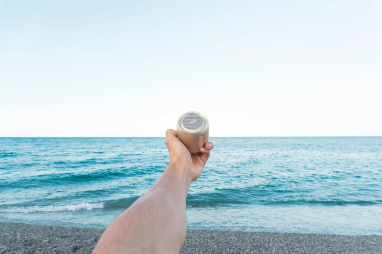 a person holding a can of beer on a beach, an album cover, unsplash, paper cup, 120 degree view, trending on dezeen, high resolution product photo