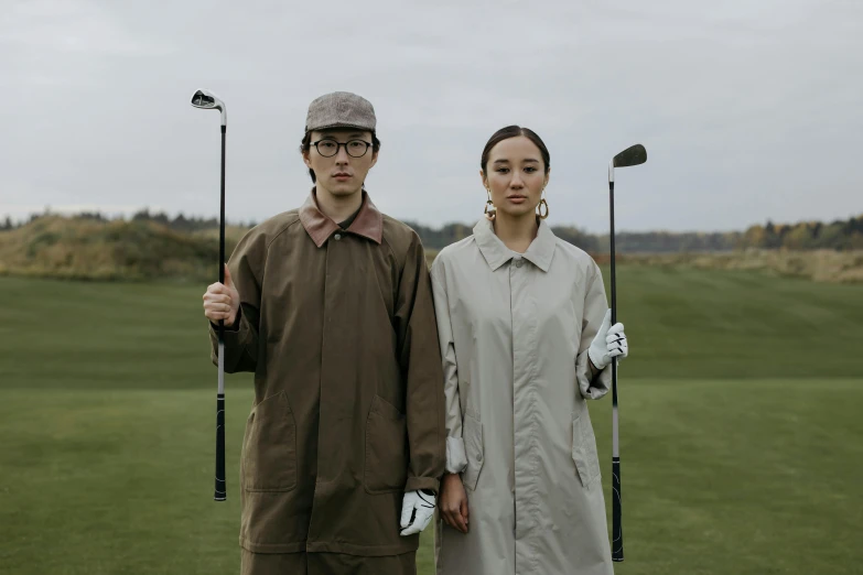 a man and a woman standing next to each other holding golf clubs, a portrait, unsplash, renaissance, wearing japanese techwear, kiko mizuhara, thumbnail, brown clothes