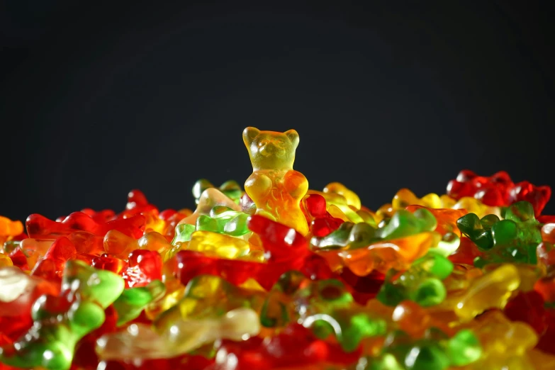 a pile of gummy bears sitting on top of each other, an album cover, by Julia Pishtar, pexels, visual art, closeup 4k, edible, beads, made in blender