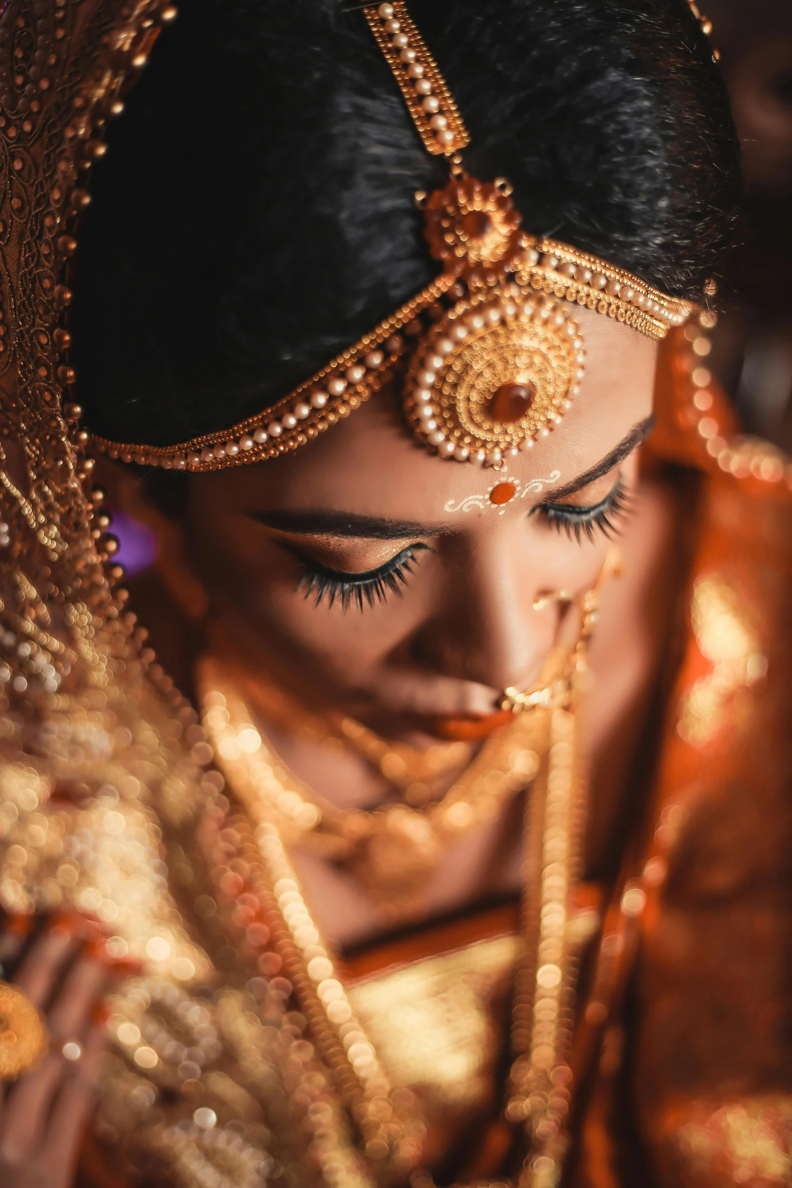 a close up of a woman in a gold dress, by Rajesh Soni, pexels contest winner, hurufiyya, wearing traditional garb, intricate led jewellery, sri lanka, a hyper realistic