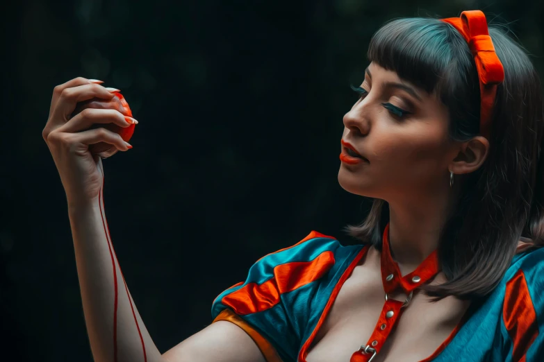 a woman holding a red object in her hand, an album cover, inspired by Elsa Bleda, pexels contest winner, magic realism, young beautiful amouranth, holding a small vape, retro 5 0 s style, cosplay photo