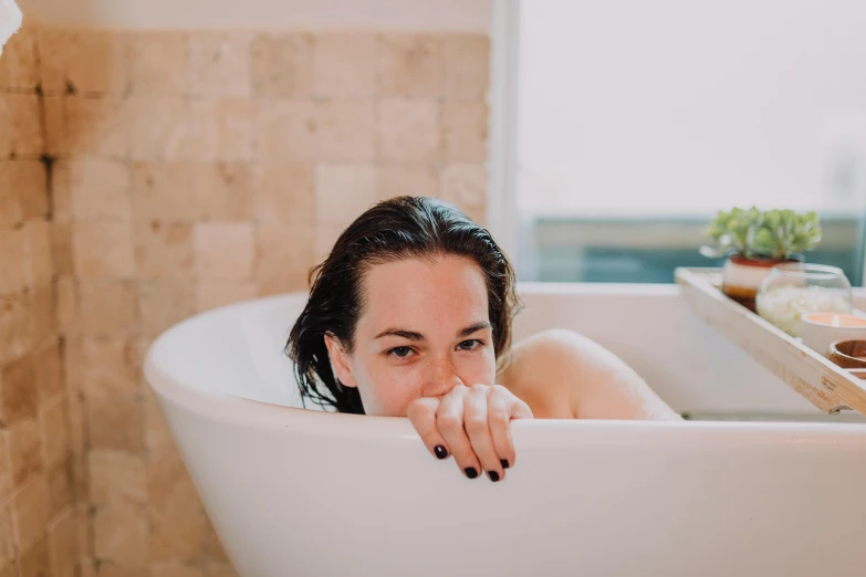 a woman taking a bath in a bathtub, pexels contest winner, white cheeks, manuka, carson ellis, over the shoulder