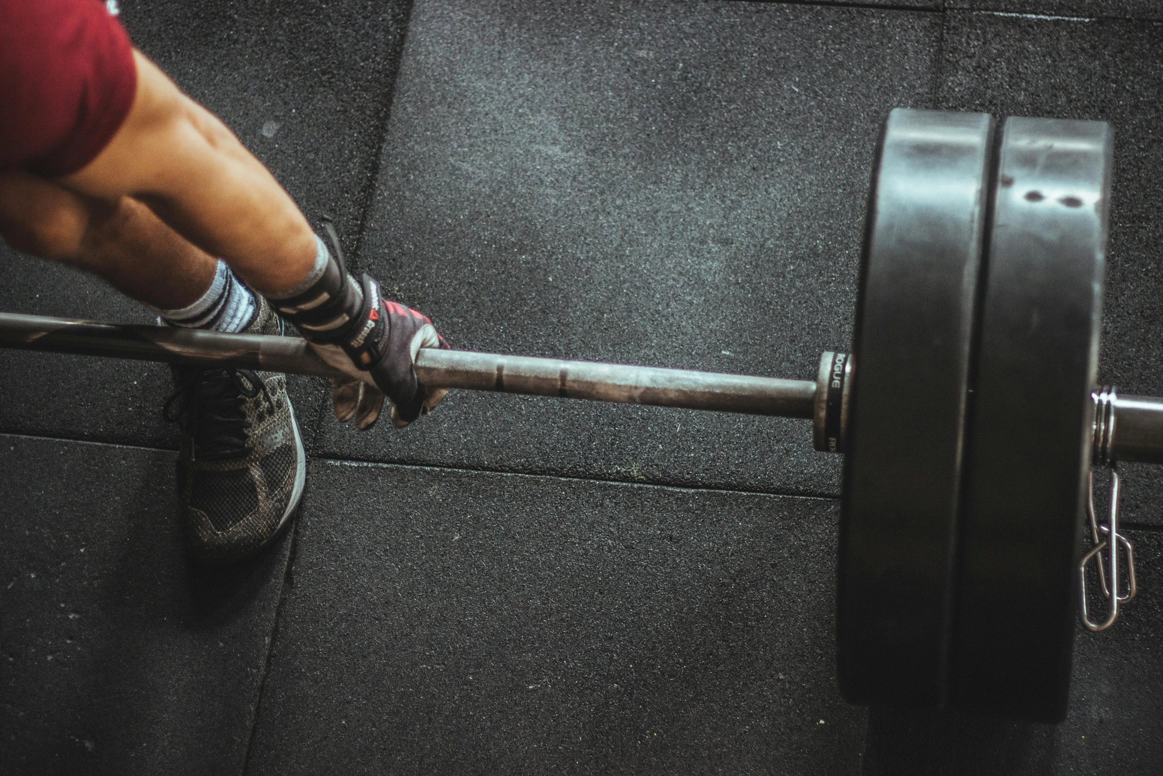 a close up of a person holding a barbell, pexels contest winner, about to step on you, avatar image, sweeping, iron