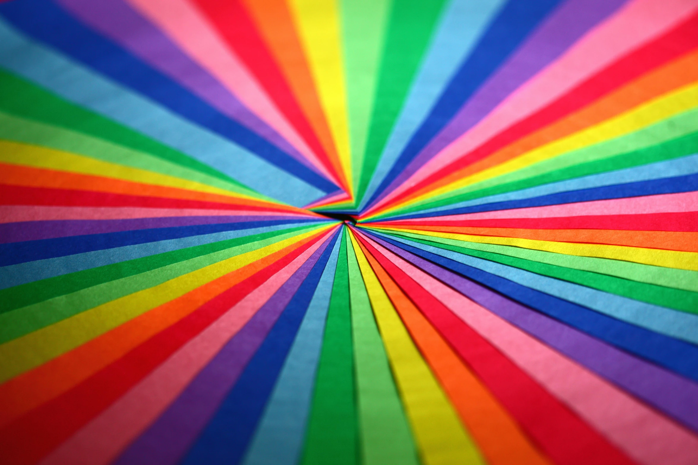 a close up of a rainbow colored umbrella, an album cover, inspired by Gabriel Dawe, pexels, paper decoration, radial light, multicoloured, colorul