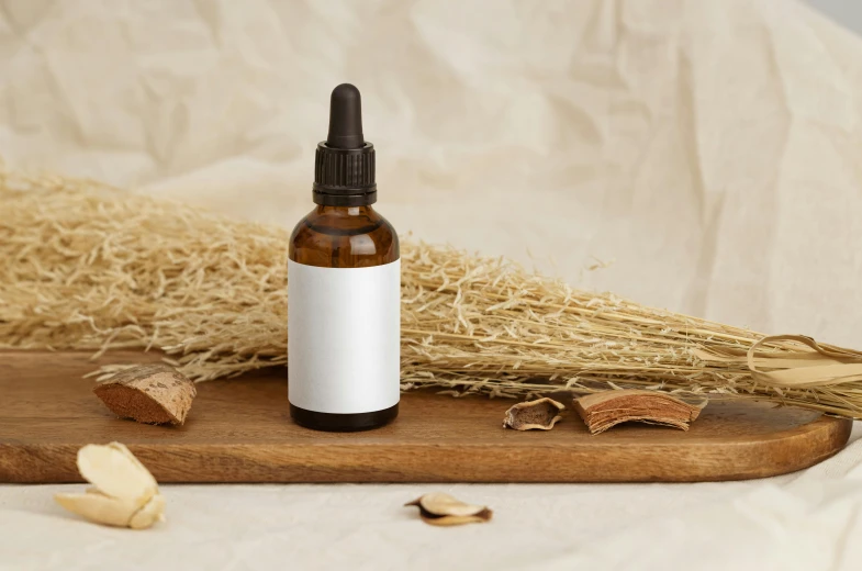 a bottle of essential oil sitting on a cutting board, by Jessie Algie, trending on pexels, relaxed dwarf with white hair, roots and hay coat, trending on dezeen, seeds