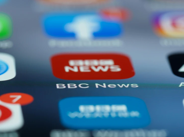 a close up of a cell phone with the bbc news app on the screen, by Paul Bird, happening, ap, unblur, taken in 2 0 2 0, abcdefghijklmnopqrstuvwxyz