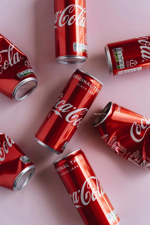 six cans of coca cola on a white surface, inspired by Dorothy Coke, trending on unsplash, maroon red, made of nanomaterials, teenage girl, directional sunlight skewed shot