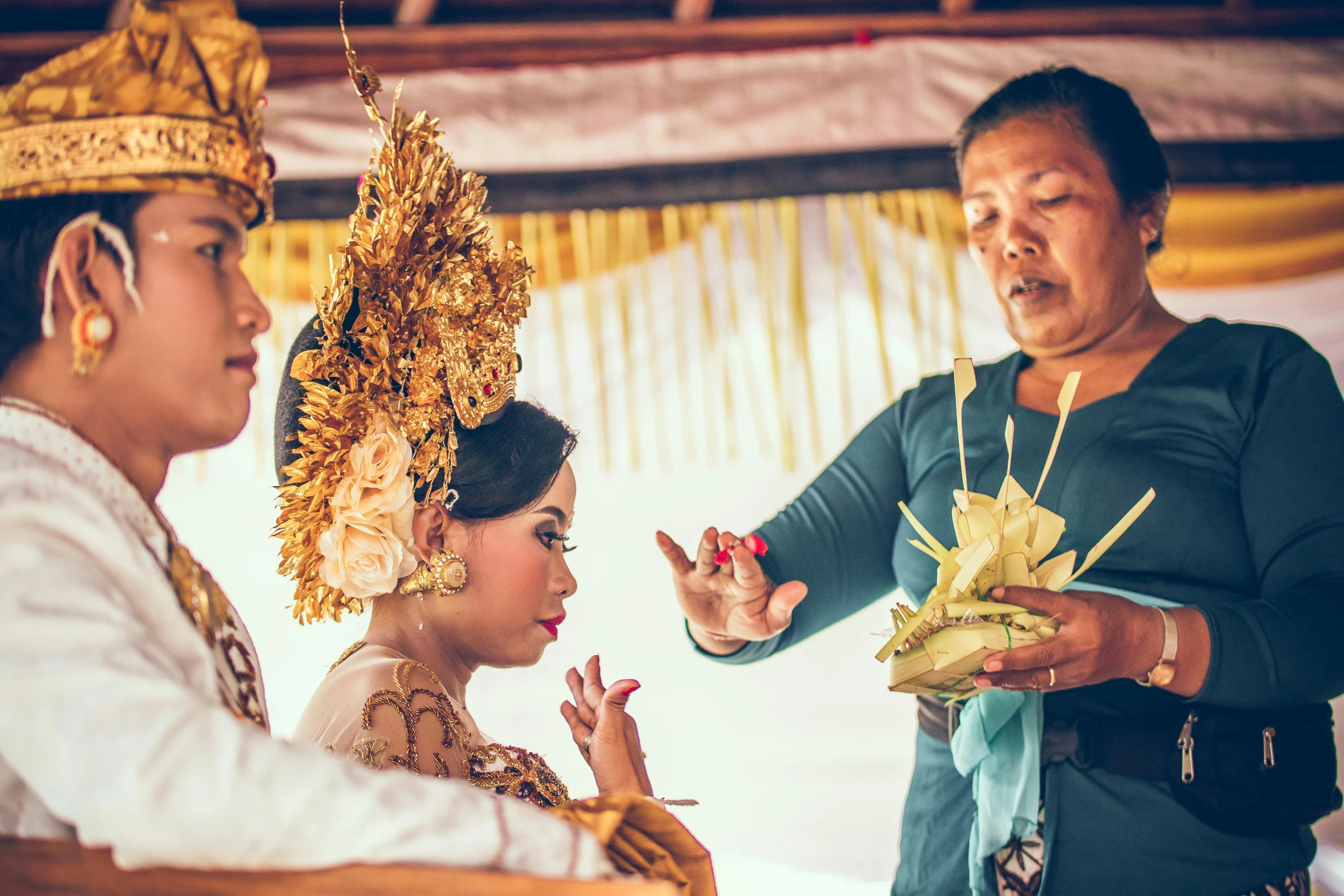 a couple of women standing next to each other, by Dan Content, pexels contest winner, happening, ceremonial ritual, square, gold floral headdress, woman holding another woman