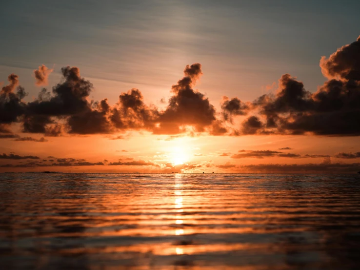 the sun is setting over a body of water, pexels contest winner, exotic endless horizon, orange clouds, youtube thumbnail, photo of the middle of the ocean