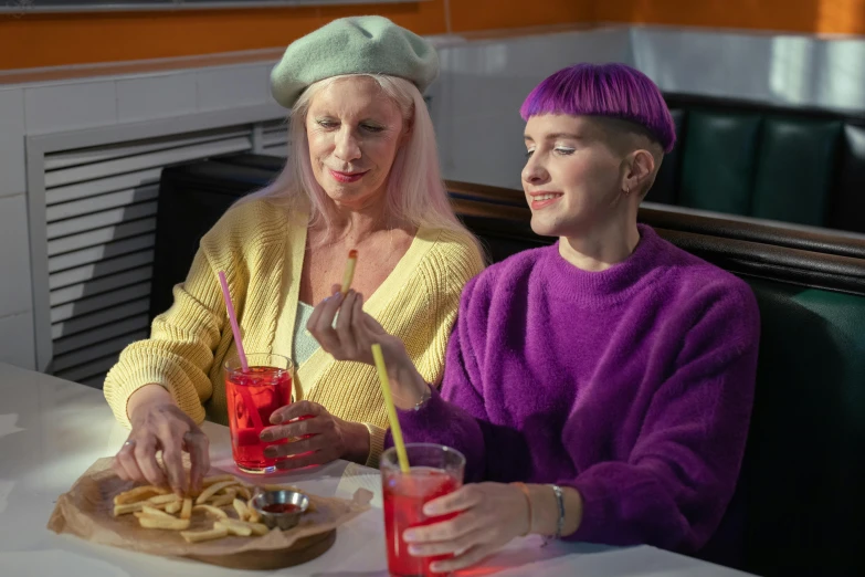 a couple of people that are sitting at a table, trending on pexels, fantastic realism, she has purple hair, serving fries, dressed anya taylor - joy, older woman