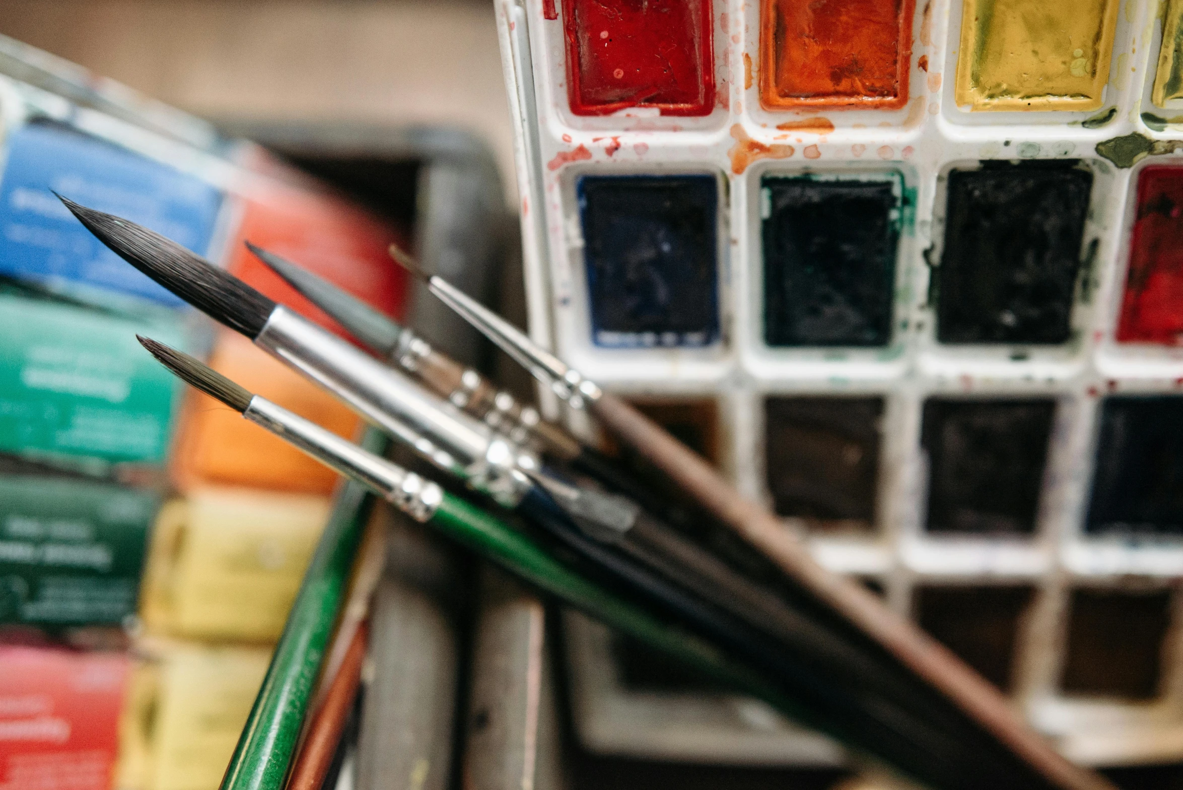 a close up of a bunch of paint brushes, a watercolor painting, inspired by Kyffin Williams, trending on pexels, multicoloured, art workstation, an intricate, 🎨🖌