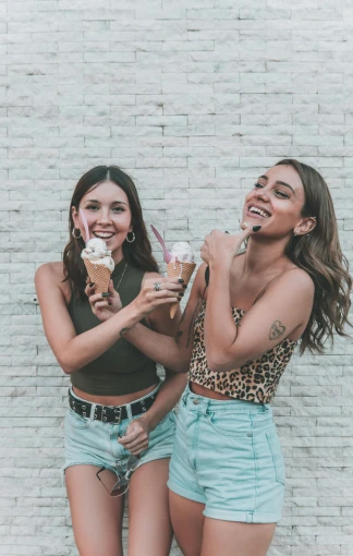 two women standing next to each other eating ice cream, trending on pexels, isabela moner, happy friend, digital image, tanned