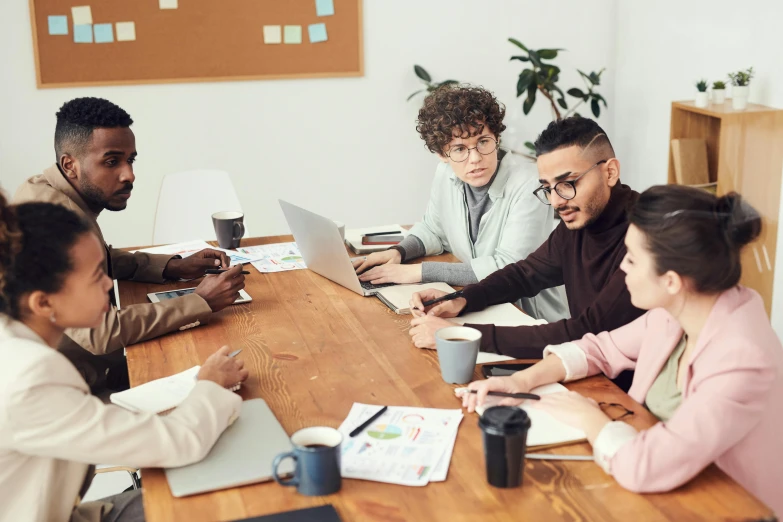 a group of people sitting around a wooden table, a cartoon, trending on pexels, innovation, mid shot photo, thumbnail