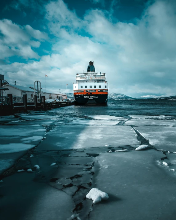 a large boat floating on top of a body of water, by Sebastian Spreng, pexels contest winner, cold snow outside, reykjavik junior college, a photograph of a rusty, 🚿🗝📝