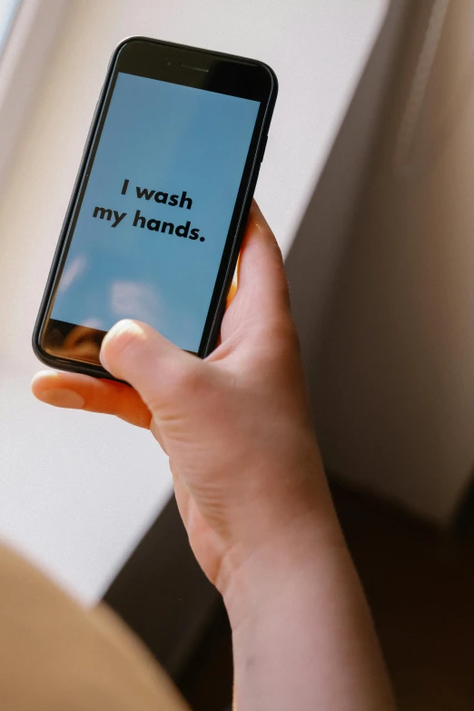 a close up of a person holding a cell phone, by Julia Pishtar, commercial washroom hand dryer, messages, my home, no text