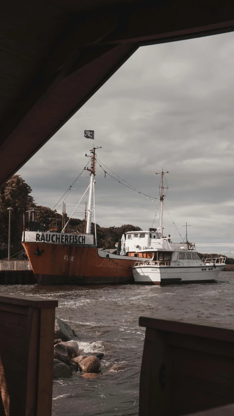 a boat that is sitting in the water, a colorized photo, by Sebastian Spreng, unsplash, bauhaus, ships in the harbor, brown, 🚿🗝📝