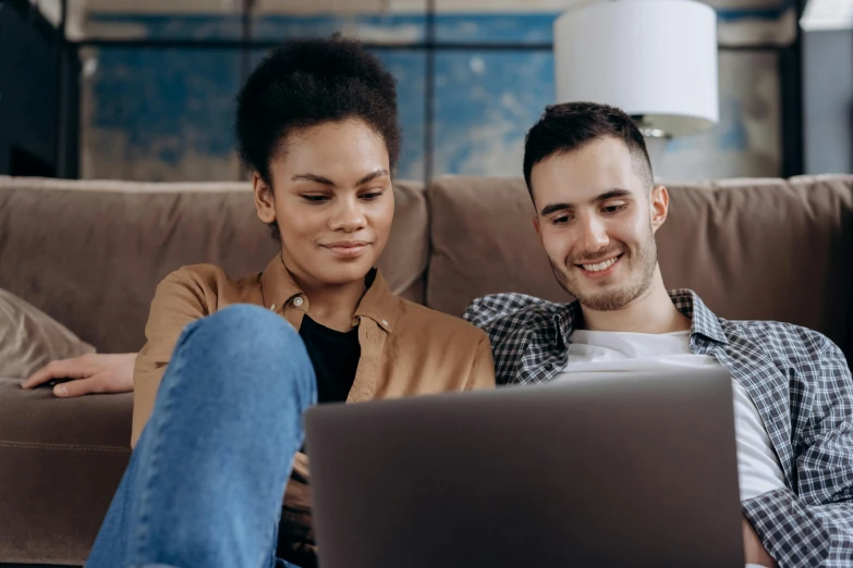 a man and woman sitting on a couch looking at a laptop, trending on pexels, renaissance, brown, raphael lecoste, medium close up shot, avatar image