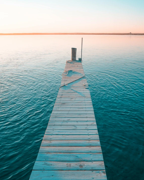 a dock in the middle of a body of water, an album cover, pexels contest winner, calm colors, vertical orientation, boardwalk, viral post