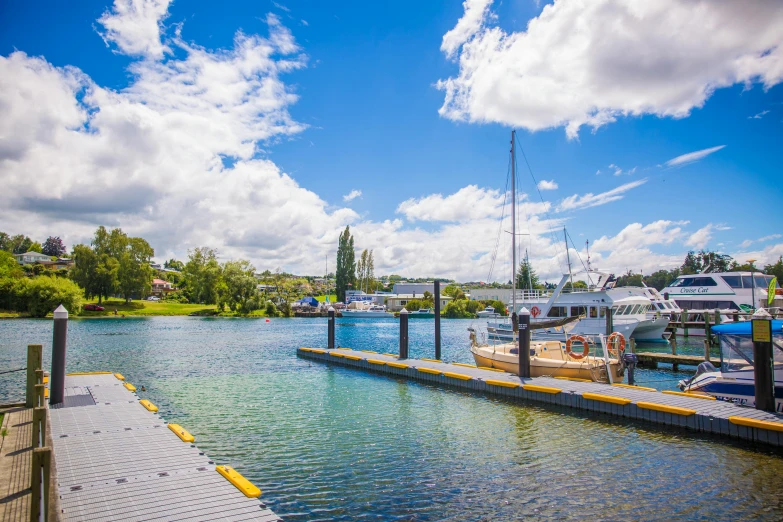 a marina filled with lots of boats under a blue sky, unsplash, hurufiyya, sydney park, lakes and waterfalls, gordon onslow ford, small dock