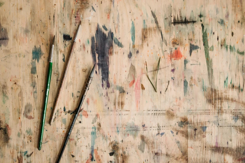 a pair of scissors sitting on top of a wooden table, a detailed painting, inspired by Pollock, unsplash, pencil marks hd, sam gilliam, 144x144 canvas, studio floor