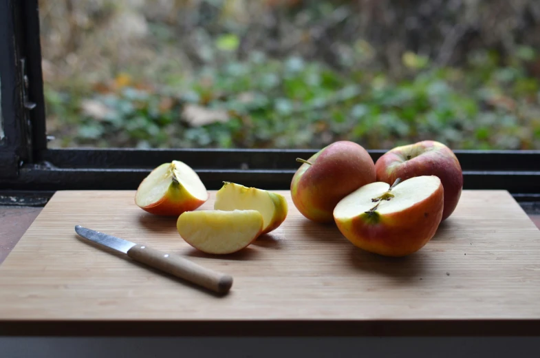 a cutting board with apples and a knife on it, inspired by Richmond Barthé, lightweight, close scene, autumnal, peach