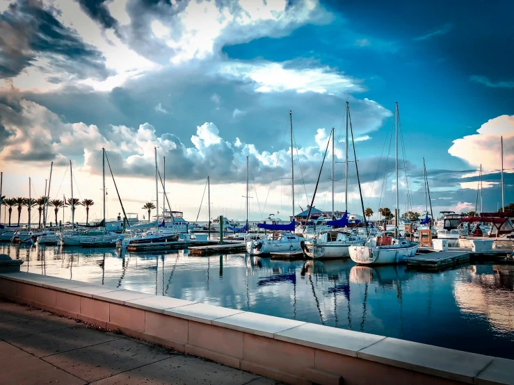 a marina filled with lots of boats under a cloudy sky, pexels contest winner, florida, avatar image, hard morning light, graphic print