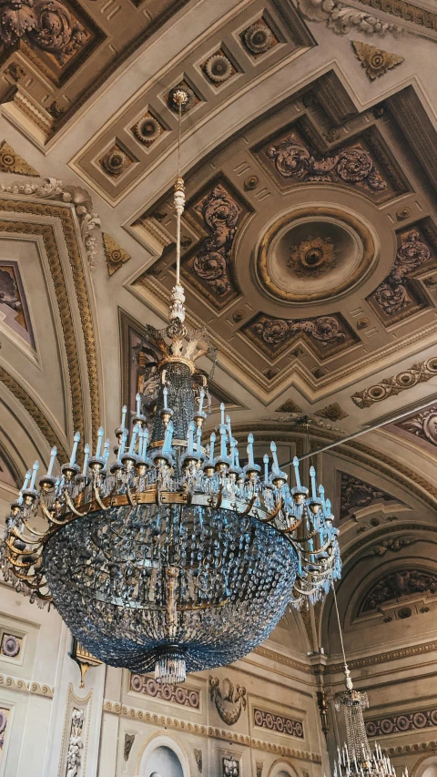 a chandelier hanging from the ceiling in a large room, by Anita Malfatti, unsplash contest winner, rococo, brown and cyan blue color scheme, square, detailed classical architecture, demur