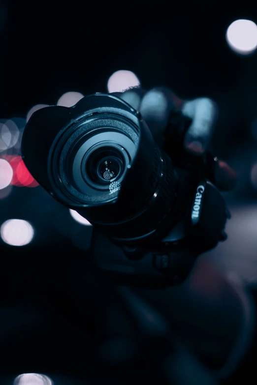 a close up of a person holding a camera, pexels contest winner, night time footage, telephoto, wide angle”, ultrawide lens”