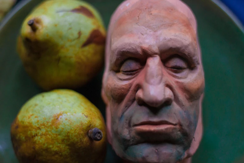 a close up of a plate of fruit with a man's face, a surrealist sculpture, inspired by Richard Corben, trending on zbrush central, a portrait of dwayne johnson, detailed clay model, scumbled thick oil paint, pear for a head